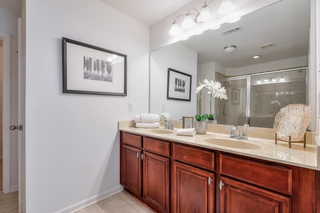 bathroom featuring a shower stall, visible vents, and a sink