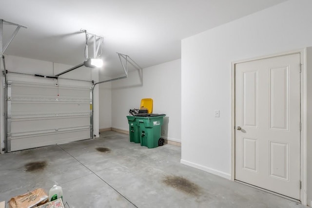 garage with a garage door opener and baseboards