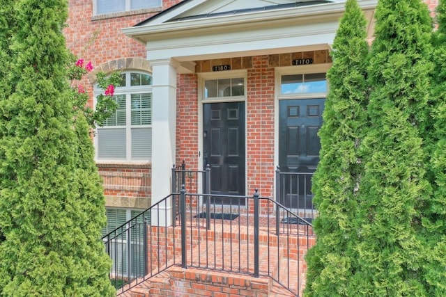 property entrance featuring brick siding