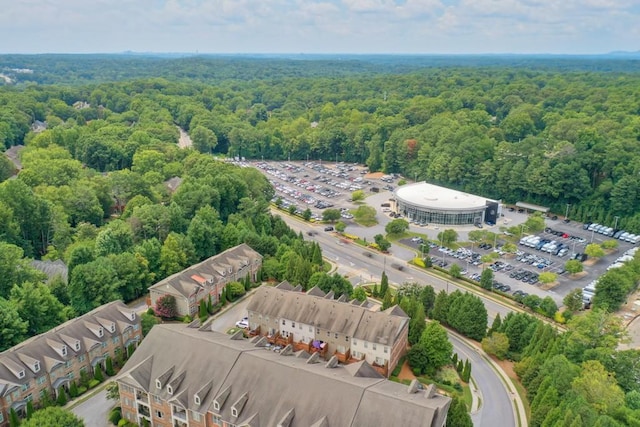 birds eye view of property featuring a view of trees