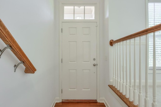 entryway featuring baseboards and wood finished floors