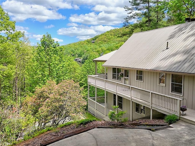 1133 Ridgepole Dr, Sky Valley, GA 30537 - rear view of house with a forest view, a metal roof, and a balcony