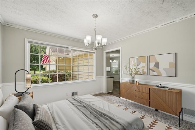 2466 Country Club Dr, Conyers, GA 30013 - bedroom featuring a chandelier, a textured ceiling, crown molding, multiple windows, and wood finished floors