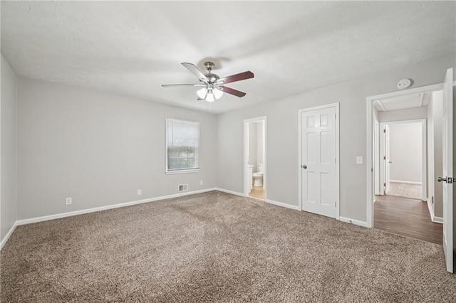 2466 Country Club Dr, Conyers, GA 30013 - unfurnished bedroom featuring carpet, attic access, a textured ceiling, ensuite bathroom, and a ceiling fan