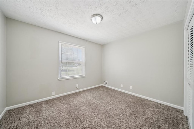 2466 Country Club Dr, Conyers, GA 30013 - unfurnished bedroom with carpet, a textured ceiling, and a closet