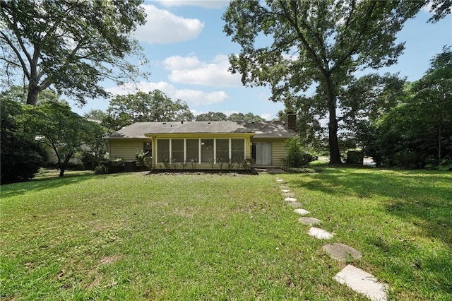 2466 Country Club Dr, Conyers, GA 30013 - rear view of property with a sunroom, a chimney, and a yard