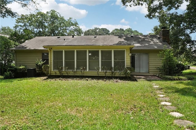 2466 Country Club Dr, Conyers, GA 30013 - back of house with a chimney, a lawn, and a sunroom