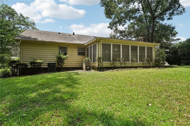 2466 Country Club Dr, Conyers, GA 30013 - back of house with a sunroom, a yard, and a chimney