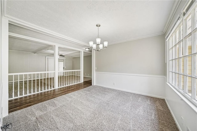 2466 Country Club Dr, Conyers, GA 30013 - spare room with carpet floors, a chandelier, plenty of natural light, a textured ceiling, and crown molding