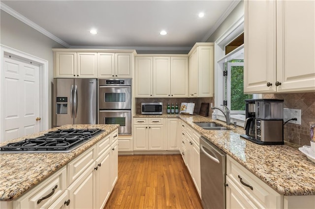 290 Edwardton Ct, Roswell, GA 30076 - kitchen featuring appliances with stainless steel finishes, crown molding, light wood-style floors, tasteful backsplash, and light stone countertops