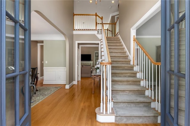 290 Edwardton Ct, Roswell, GA 30076 - entrance foyer with a high ceiling, wood finished floors, stairs, arched walkways, and wainscoting