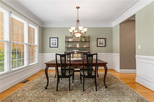 290 Edwardton Ct, Roswell, GA 30076 - dining space featuring a chandelier, a wainscoted wall, light wood-style flooring, and ornamental molding