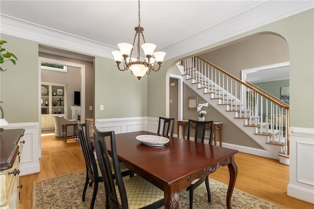 290 Edwardton Ct, Roswell, GA 30076 - dining area featuring arched walkways, light wood-style flooring, stairway, crown molding, and a chandelier