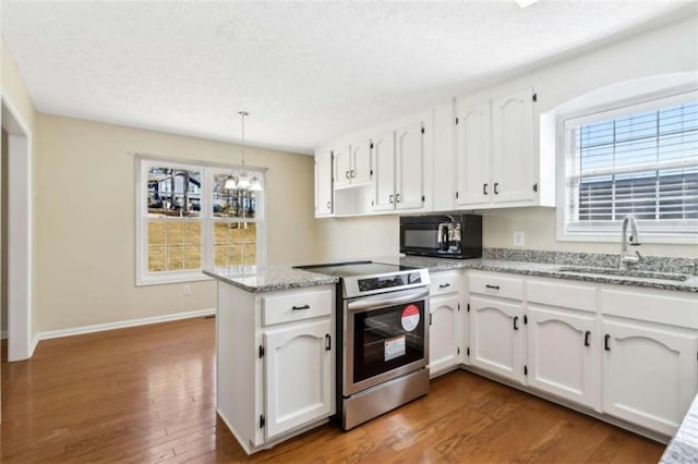 kitchen with black microwave, white cabinets, a sink, and stainless steel range with electric cooktop