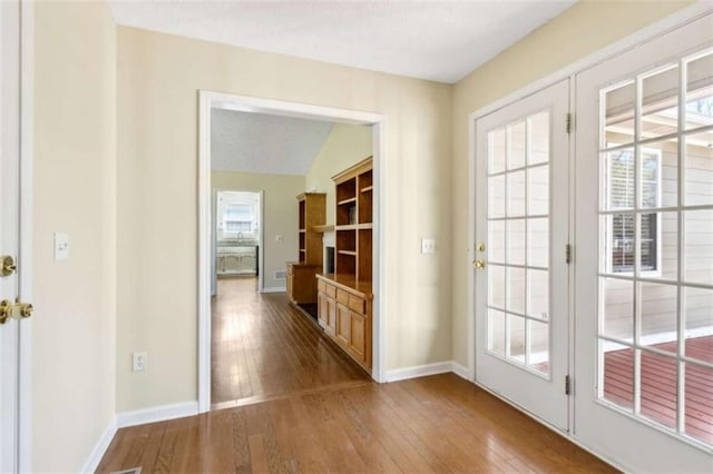 entryway featuring hardwood / wood-style floors and baseboards