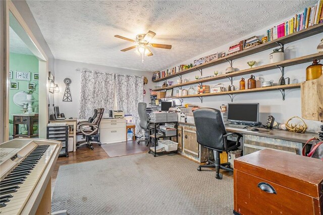 home office with ceiling fan, a textured ceiling, and hardwood / wood-style flooring