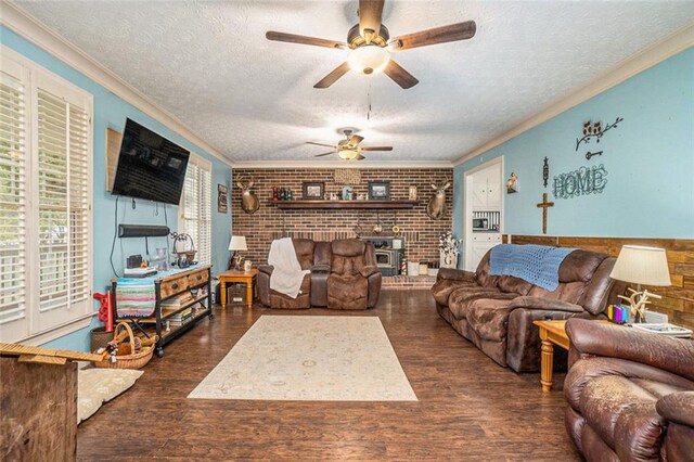 living room featuring ceiling fan, dark hardwood / wood-style flooring, ornamental molding, and a textured ceiling