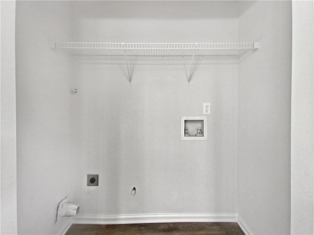 laundry room with electric dryer hookup, gas dryer hookup, dark wood-type flooring, and washer hookup