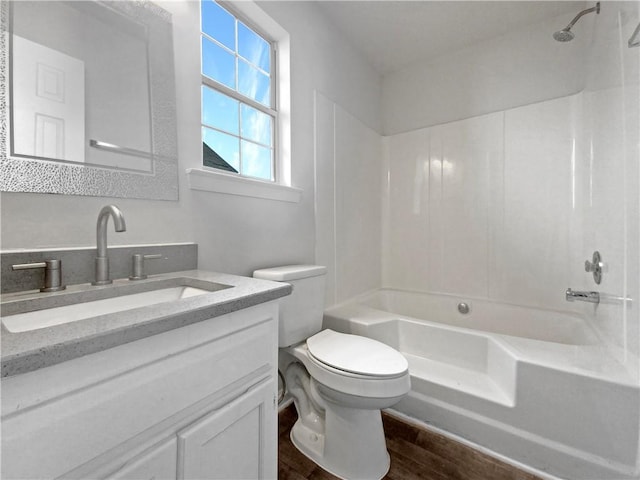 full bathroom featuring shower / bathing tub combination, vanity, toilet, and hardwood / wood-style floors