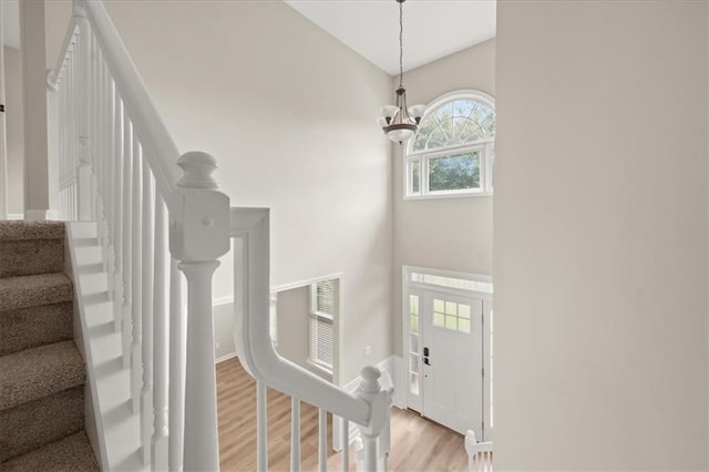 2870 Tattersall Ct, Cumming, GA 30041 - foyer featuring light wood-style flooring, stairs, a chandelier, baseboards, and high vaulted ceiling