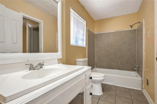 bathroom with tile patterned floors, toilet, vanity, and a textured ceiling