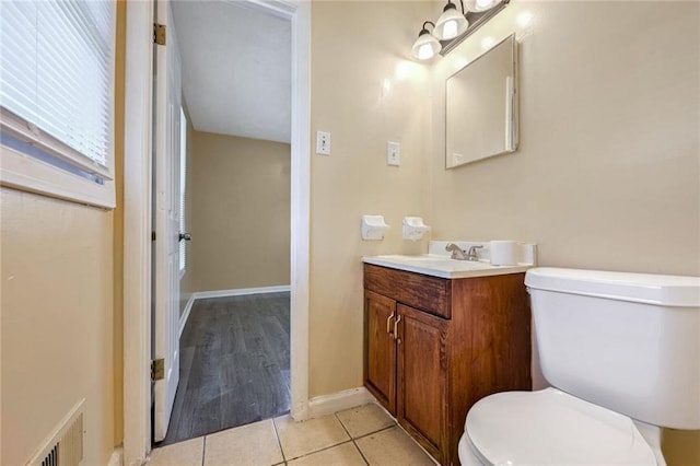 bathroom with visible vents, baseboards, toilet, tile patterned floors, and vanity