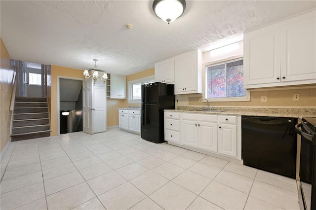 kitchen with a sink, a textured ceiling, black appliances, and white cabinets