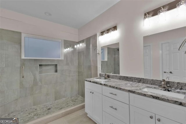 250 Stonecreek Pkwy, Covington, GA 30016 - bathroom featuring a tile shower and double vanity