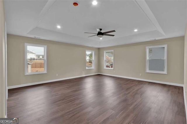 250 Stonecreek Pkwy, Covington, GA 30016 - spare room featuring a tray ceiling, a ceiling fan, dark wood-style flooring, and recessed lighting