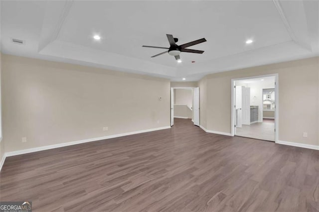 250 Stonecreek Pkwy, Covington, GA 30016 - unfurnished living room with a tray ceiling, a ceiling fan, wood finished floors, and recessed lighting