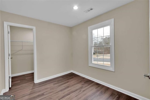 250 Stonecreek Pkwy, Covington, GA 30016 - unfurnished bedroom with wood finished floors, a closet, recessed lighting, and a spacious closet
