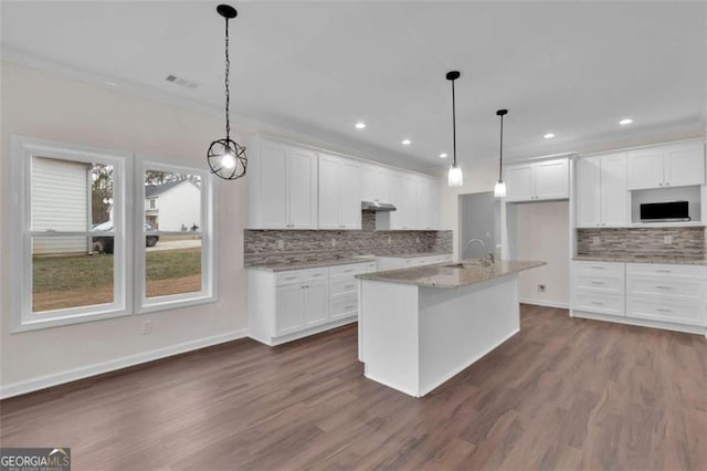 250 Stonecreek Pkwy, Covington, GA 30016 - kitchen with decorative backsplash, white cabinetry, dark wood finished floors, recessed lighting, and ornamental molding