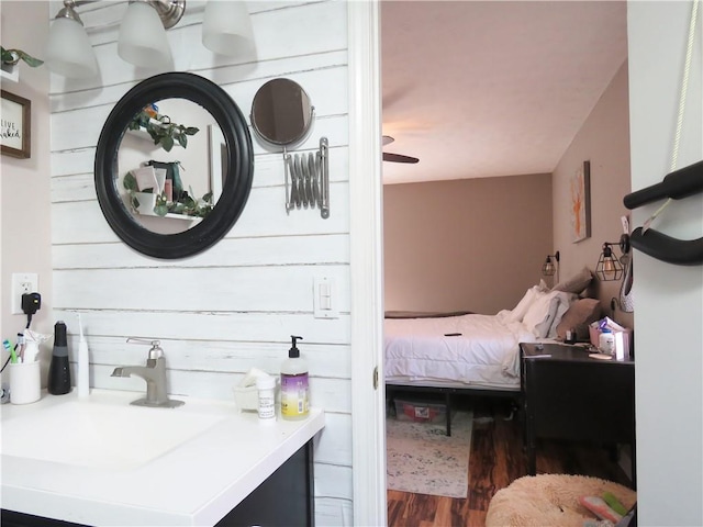 bedroom with a sink and wood finished floors