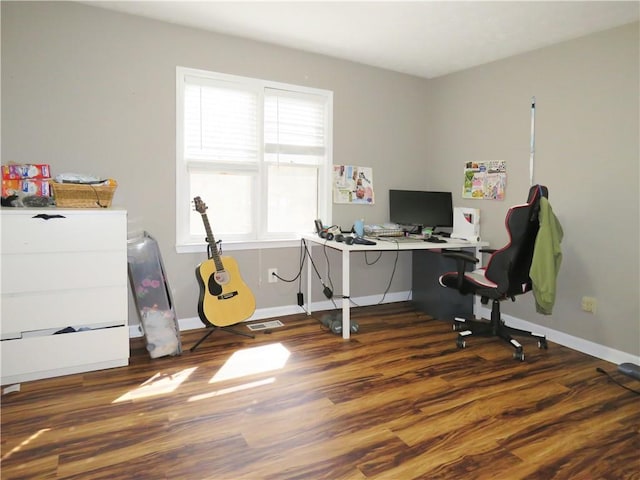 home office with visible vents, baseboards, and wood finished floors