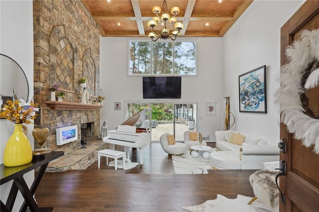 living room with wood-type flooring, wooden ceiling, a fireplace, and an inviting chandelier