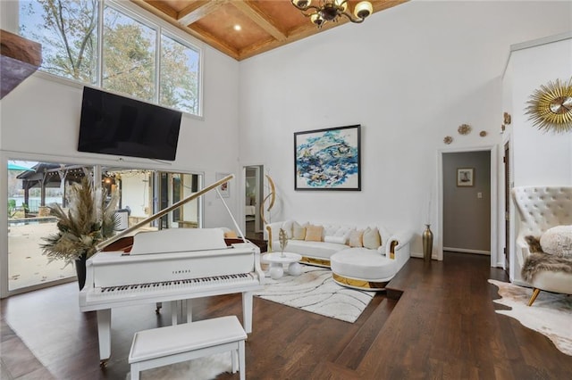 living room with beamed ceiling, a towering ceiling, dark hardwood / wood-style floors, and a chandelier
