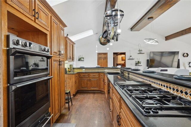 kitchen with appliances with stainless steel finishes, ornamental molding, sink, dark hardwood / wood-style floors, and hanging light fixtures