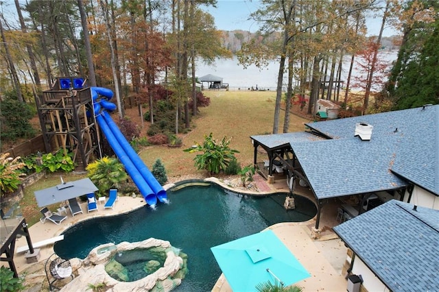 view of pool featuring an in ground hot tub, a water view, and a patio