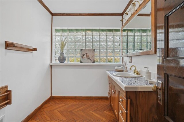 bathroom with vanity, parquet floors, and ornamental molding