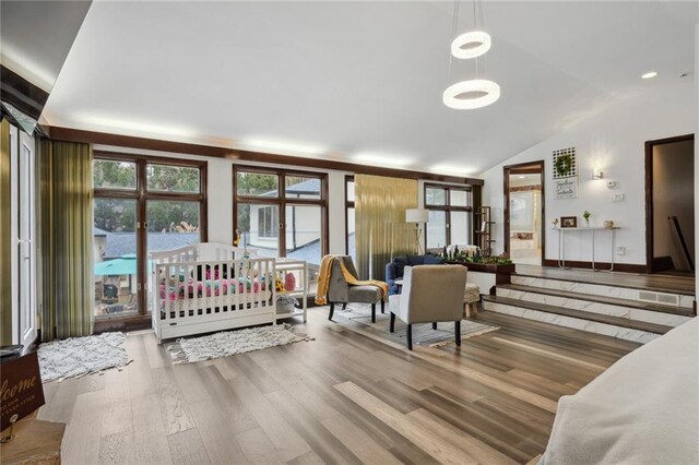 bedroom with vaulted ceiling and hardwood / wood-style flooring