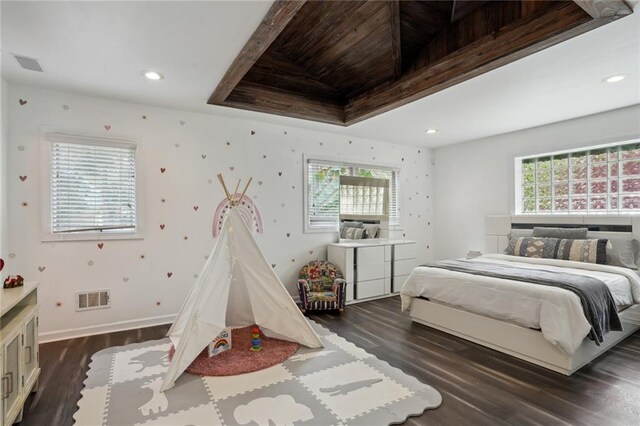 bedroom featuring beamed ceiling and dark wood-type flooring