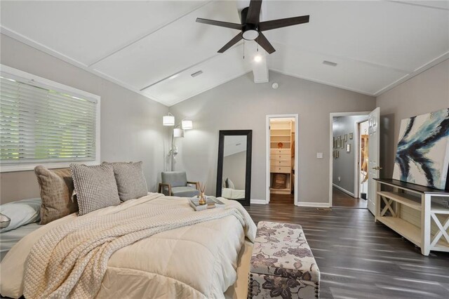bedroom featuring vaulted ceiling with beams, ceiling fan, a spacious closet, dark hardwood / wood-style flooring, and a closet
