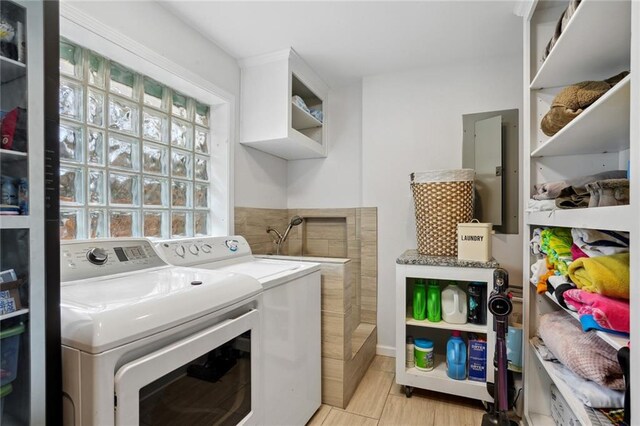 clothes washing area featuring washing machine and dryer and electric panel