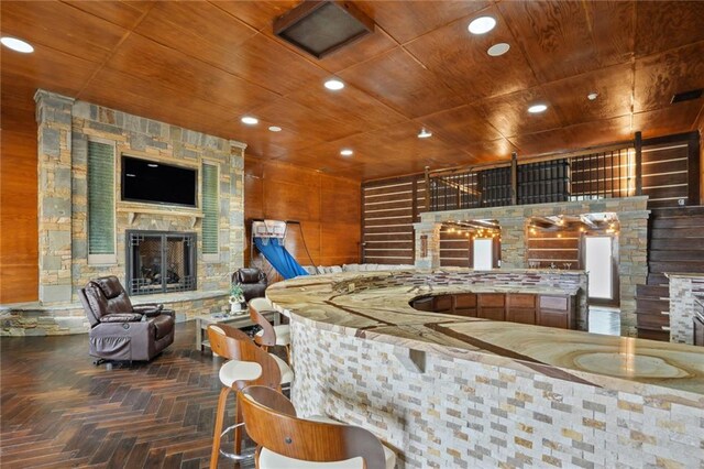 bar with wooden ceiling, a fireplace, and parquet floors
