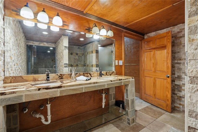 bathroom with a shower with door, sink, and wooden ceiling