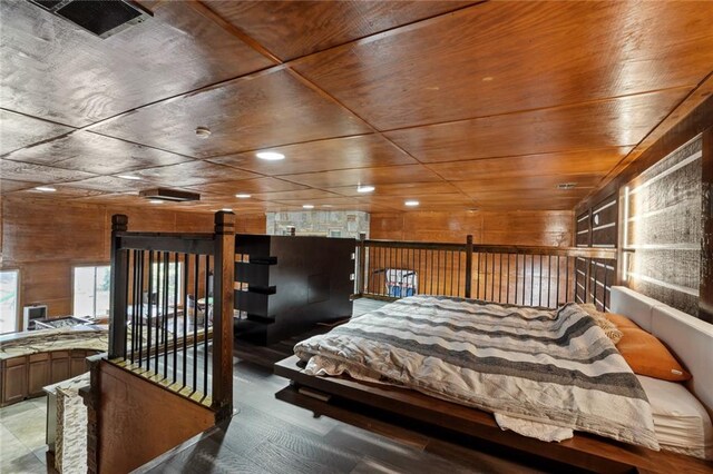 bedroom with wooden walls and wood ceiling