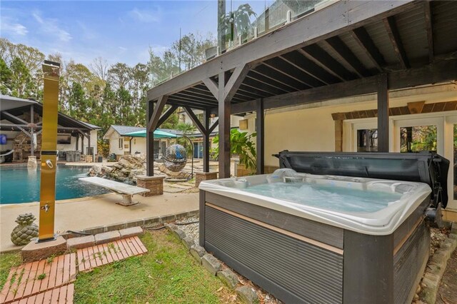 view of patio with pool water feature and a hot tub