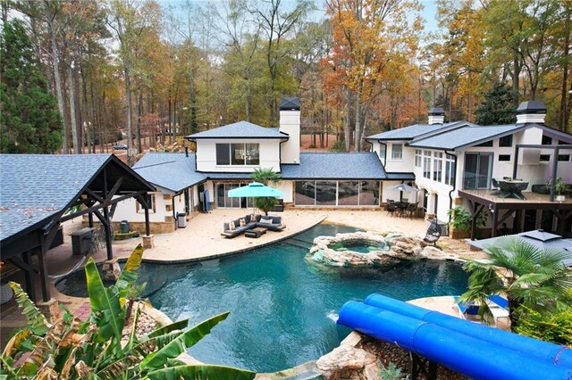 view of swimming pool featuring an in ground hot tub, a gazebo, a patio, and a sunroom