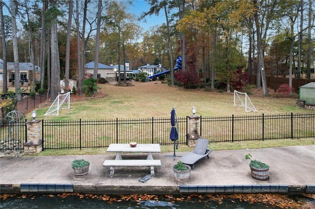 view of yard featuring a water view and a patio area