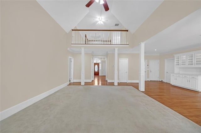 1405 Wilmington Way, Grayson, GA 30017 - unfurnished living room with a ceiling fan, high vaulted ceiling, wood finished floors, ornate columns, and baseboards